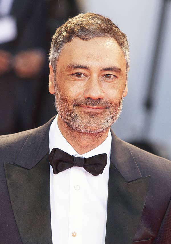Taika Waititi in a suit with a bow-tie 