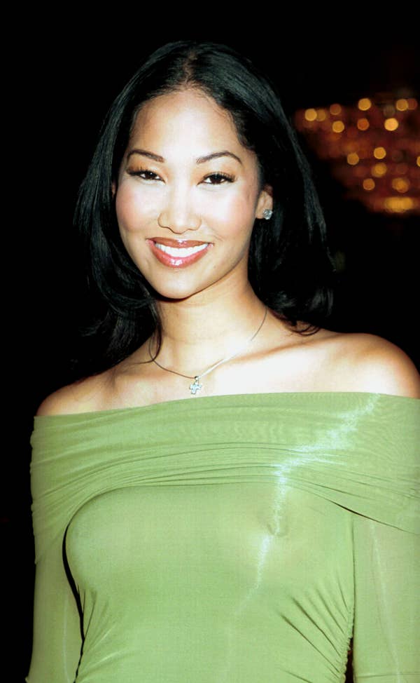 Kimora Lee Simmons with her hair down and straight, wearing a sheer green dress