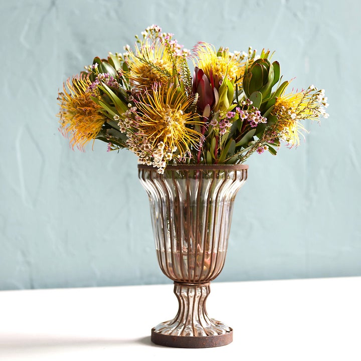 a valentine's day bouquet in a silver vase