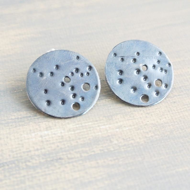 The large circular silver studs with holes in the Sagittarius constellation pattern