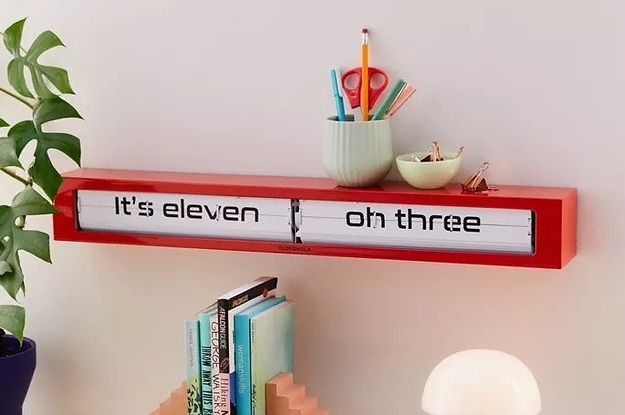 Long clock with time spelled out. There is room to use the top as a shallow shelf.