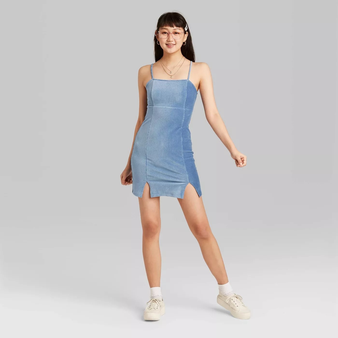 model wears light blue body con dress with two mini slips in the front 
