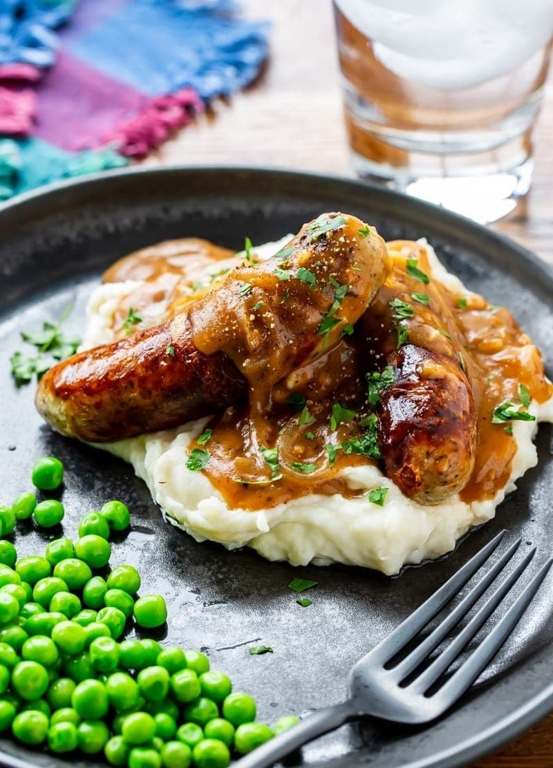 Bangers and mash with green peas.
