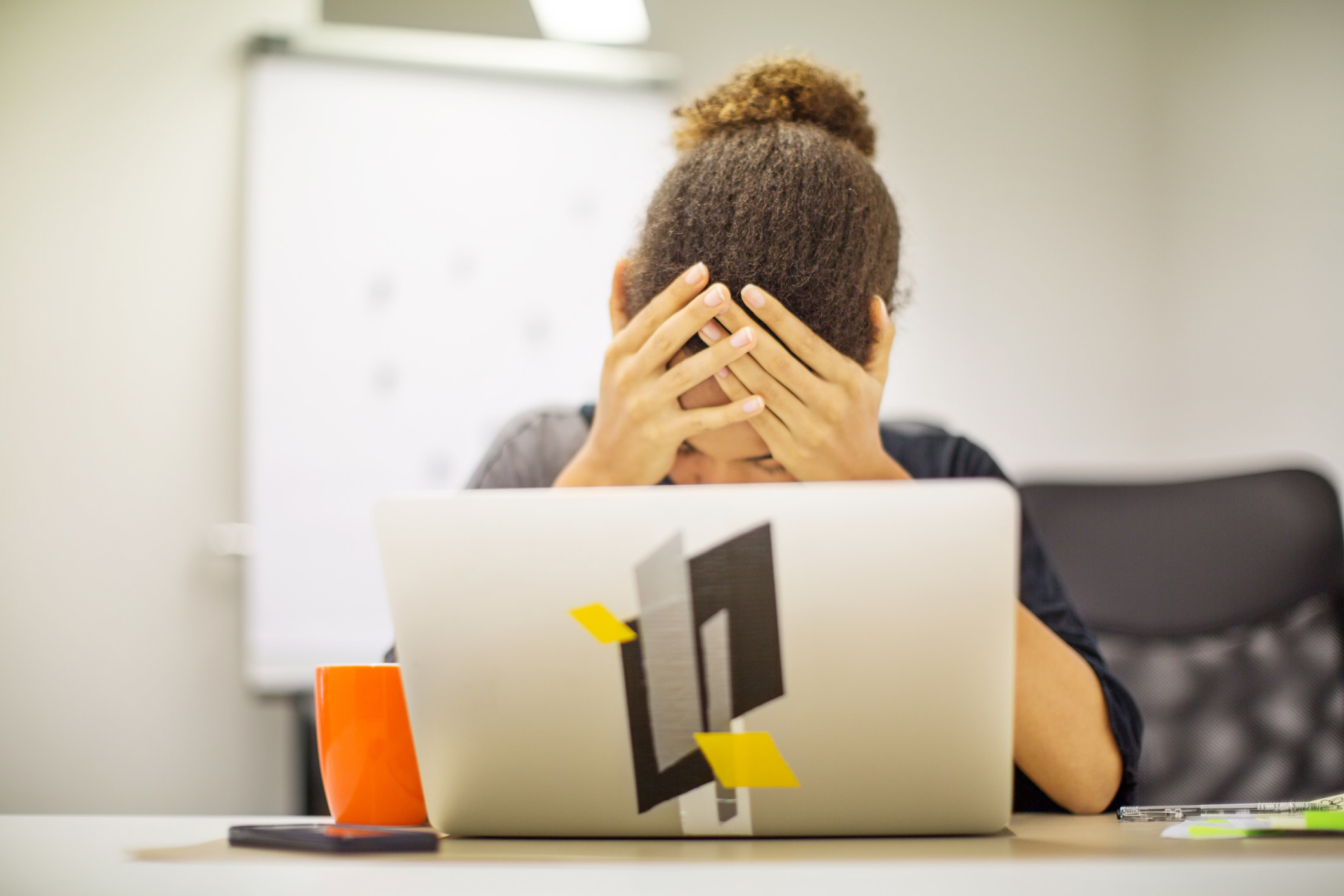 An anguished woman at a laptop