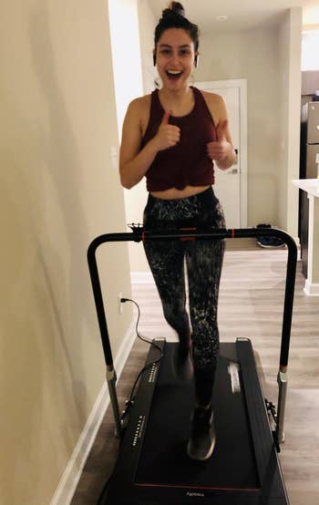 Genevieve Scarano doing a light jog on the Treadly Pro 2 in her living room with handrail up
