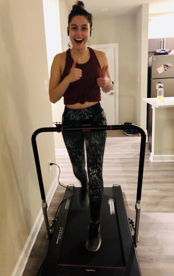 Genevieve Scarano doing a light jog on the Treadly Pro 2 in her living room with handrail up