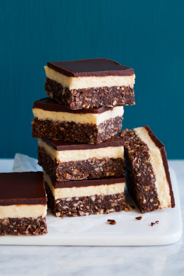 Several chocolate and nut nanaimo bars with creamy custard filling.