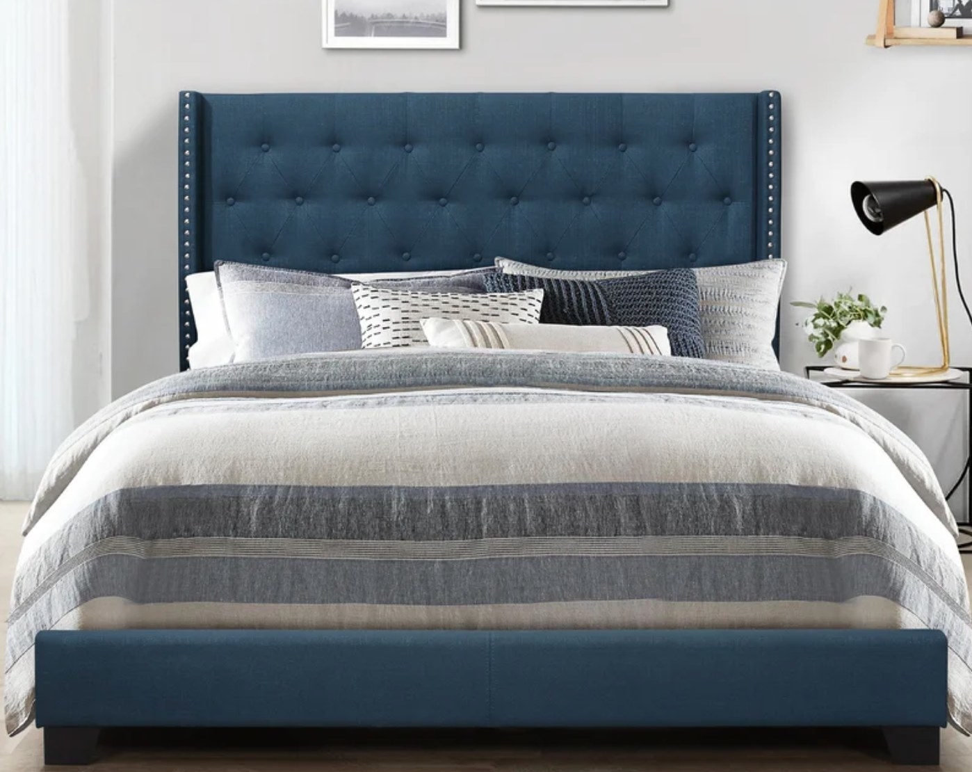 The upholstered bed frame in blue