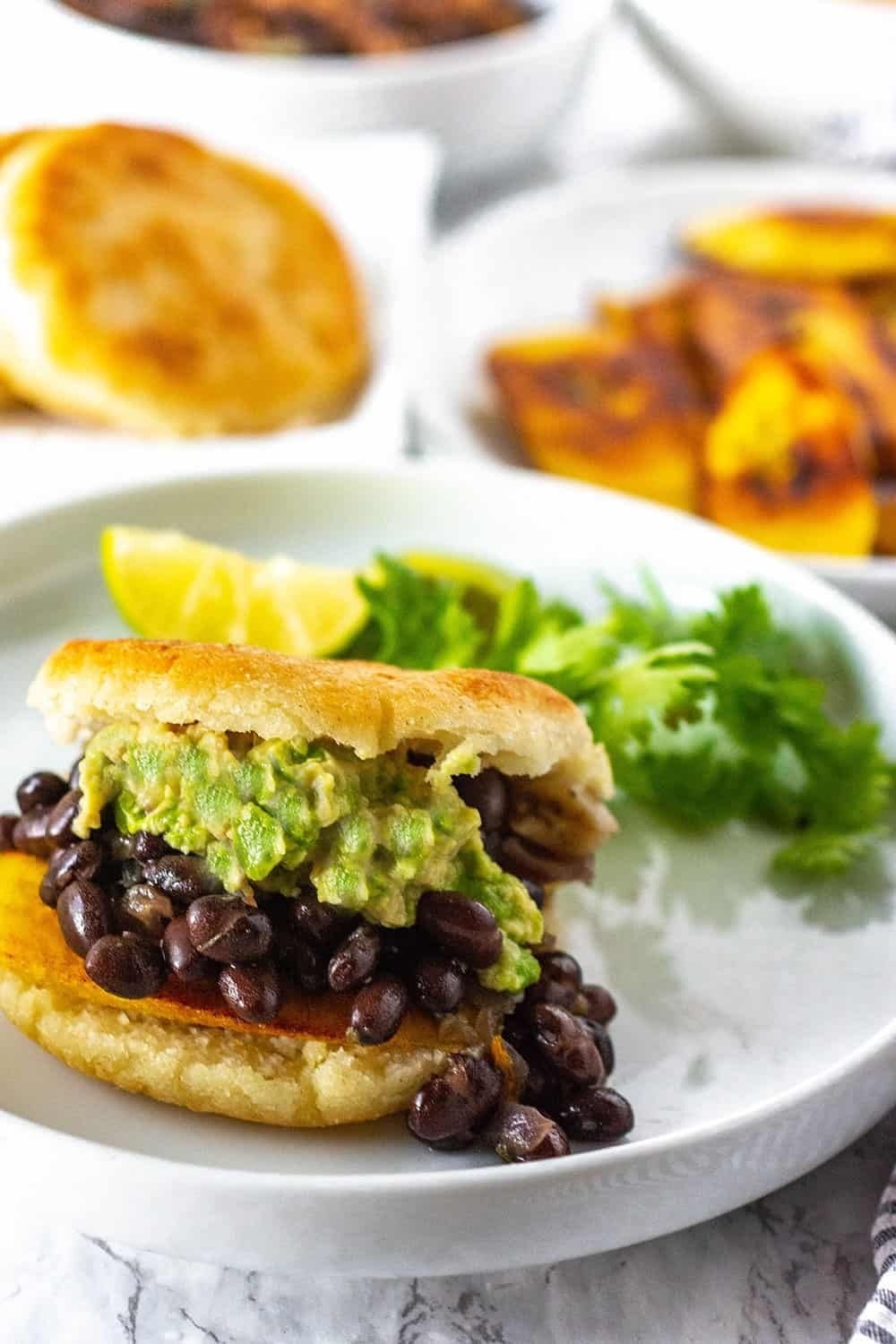 An arepa filled with beans and avocado.