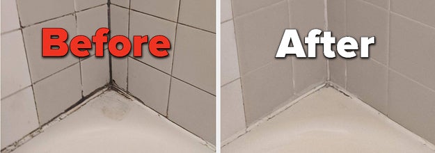 Corner of a bathtub with mold and mildew in between tiles