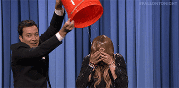 Jimmy Fallon dumping a bucket of ice water on Lindsay Lohan&#x27;s head