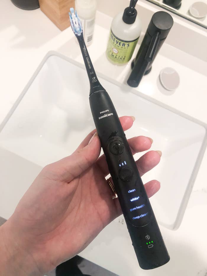 A close up of the entire toothbrush with all its options lit up