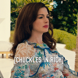 Anne Hathaway chuckling caddily 