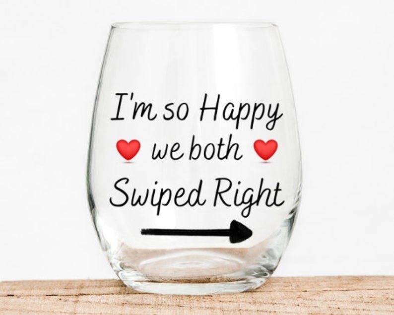 The glass reading &quot;I&#x27;m so happy we both swiped right&quot; with hearts and an arrow pointing right