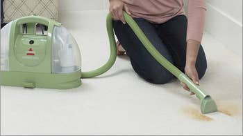 Model using Bissell Little Green cleaner on carpet