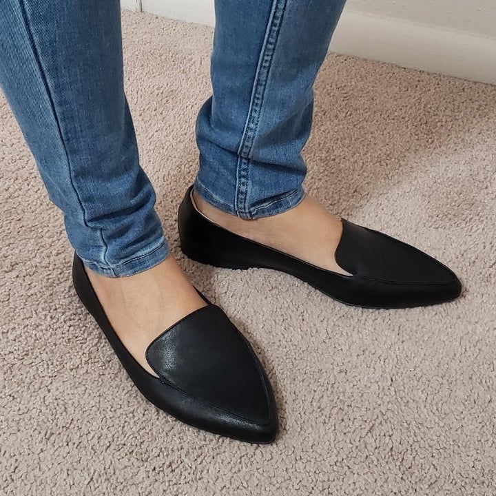 Another reviewer wearing black loafers