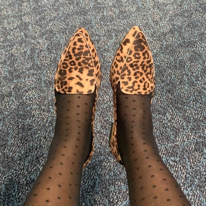 Reviewer wearing leopard print loafers