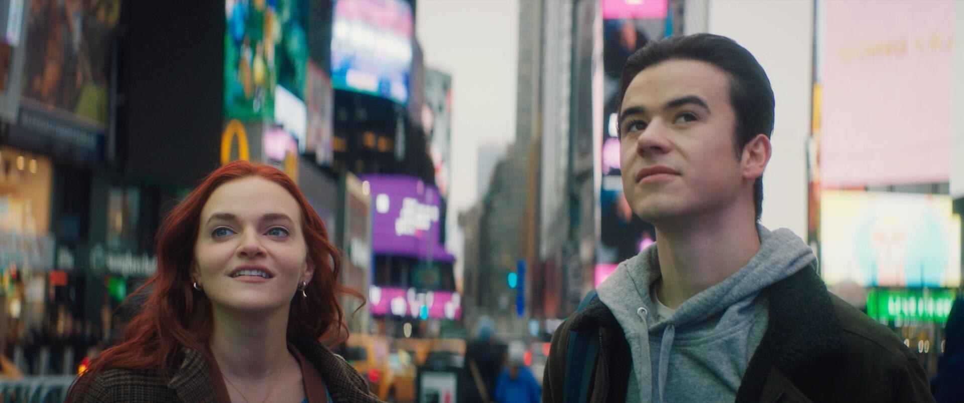 Michael and Wendy looking up at all the bright lights in Times Square.
