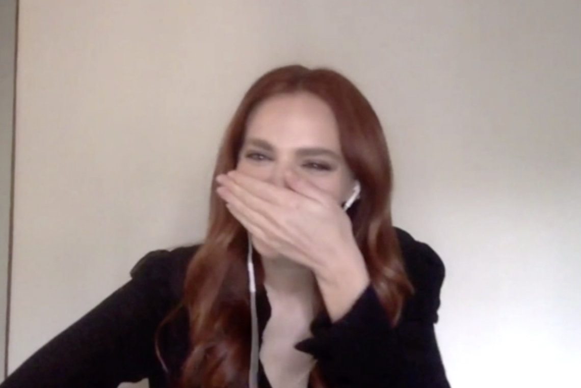 Madeline Brewer laughing and covering her mouth.