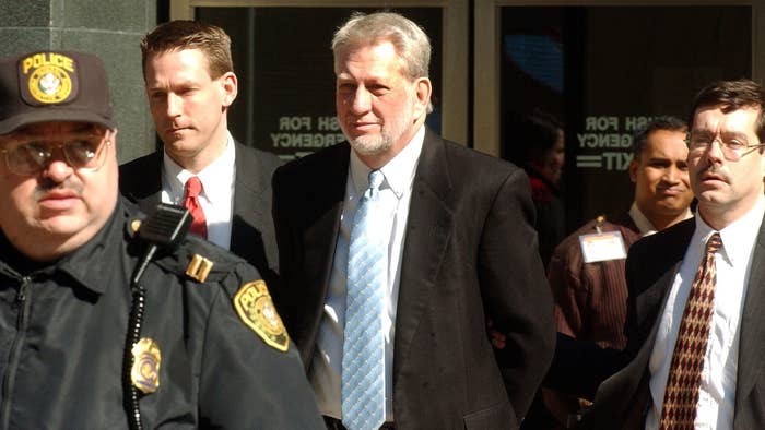 Former WorldCom CEO Bernie Eggers being escorted out of a court house by the authorities