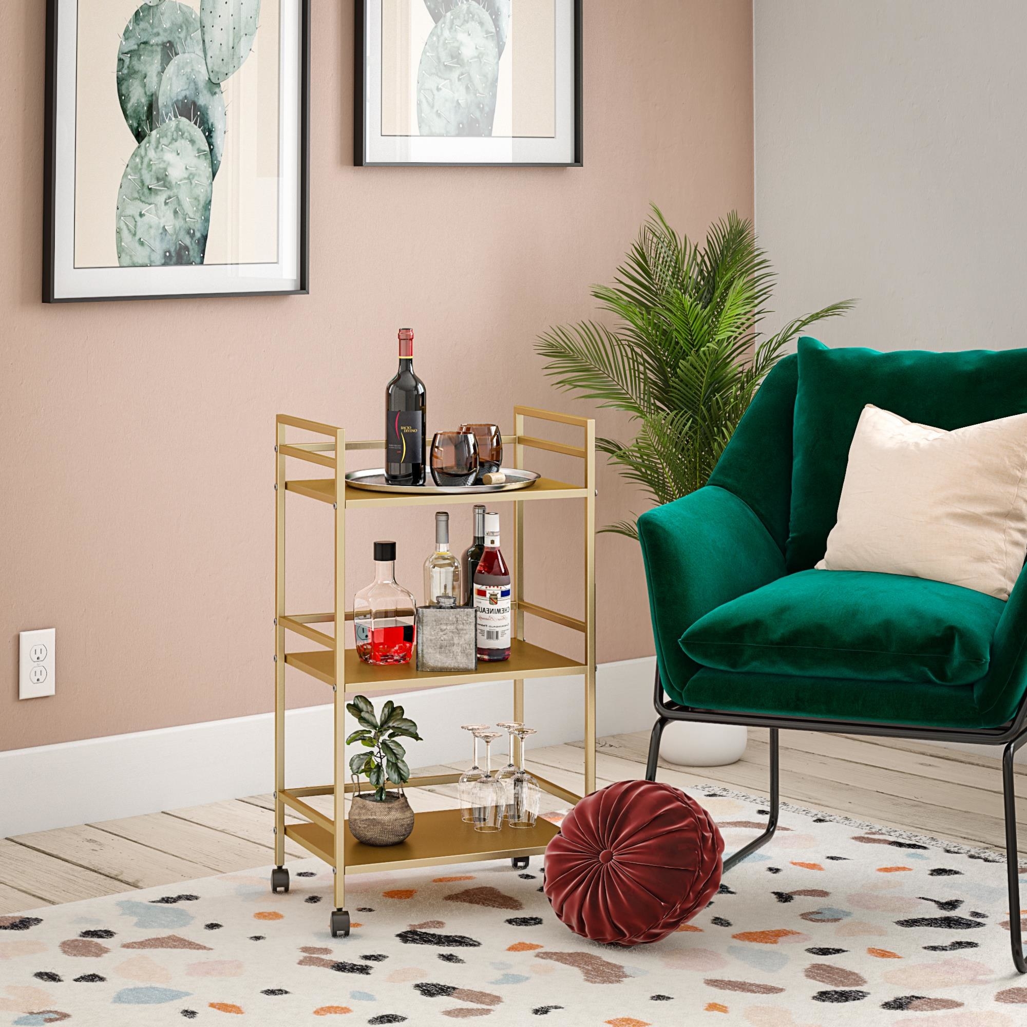 gold-finished metal cart in living room with wine and other bottles