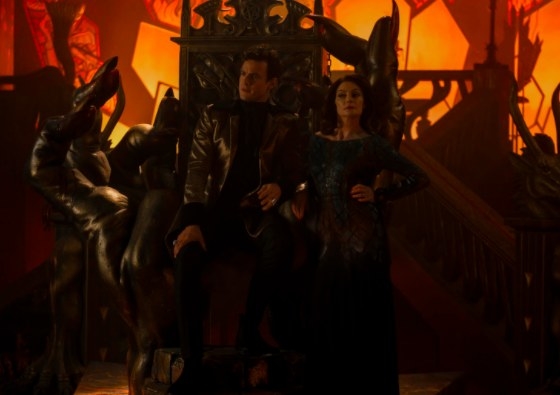 Lilith stands next to Lucifer sitting on his throne