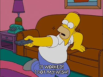 Homer Simpson watching TV on his couch with excitement