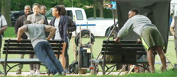 GIF of back view of Chris and Anthony doing push-ups on set