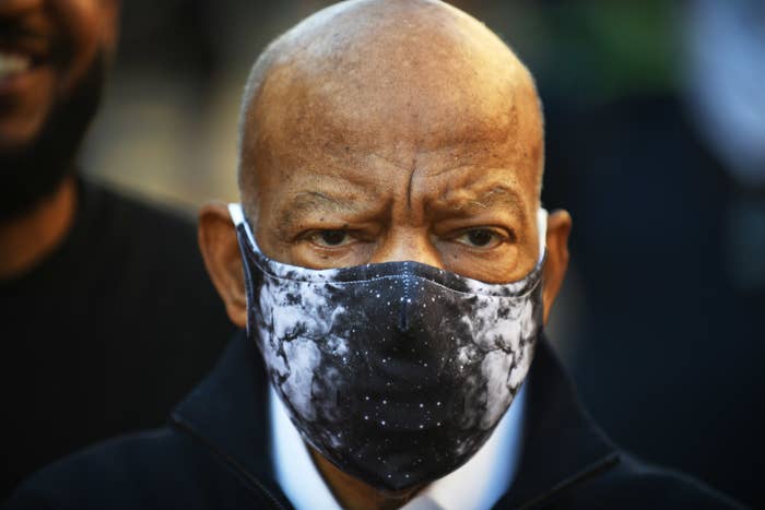 A older man is wearing a face mask and looking away from the camera
