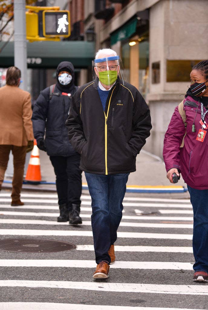 Steve walking on the street with a mask and face shield on