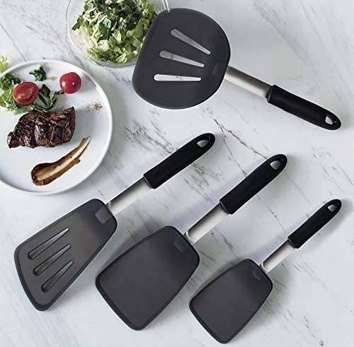 Four spatulas of varying sizes, two with strainer grooves and two without