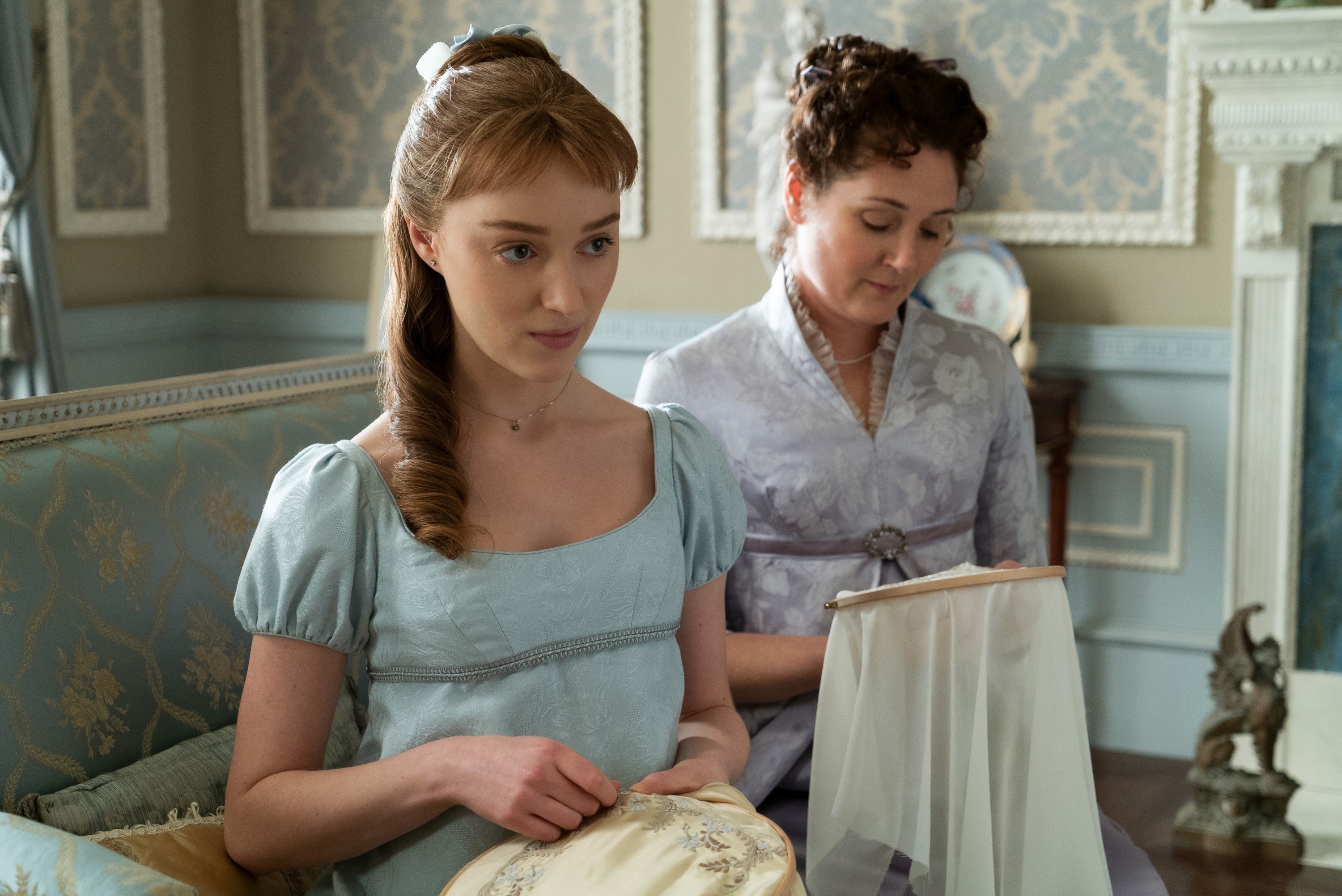 Phoebe Dynevor and Ruth Gemmell doing needlepoint work in Bridgerton