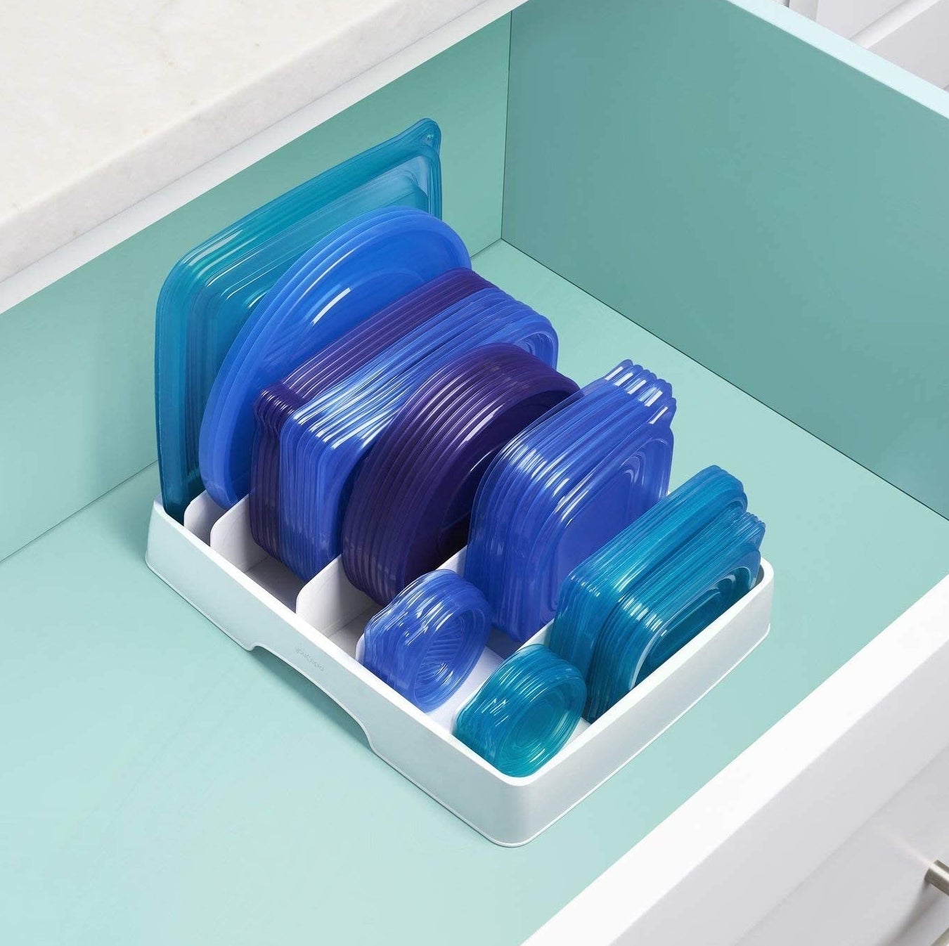 The organizer in a drawer filled neatly with food storage container lids 