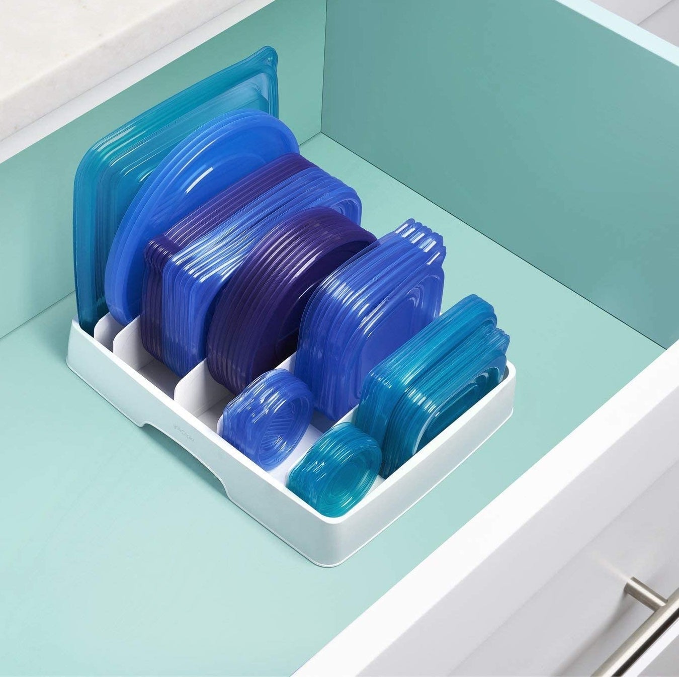 The organizer in a drawer filled neatly with food storage container lids 