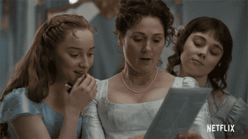Daphne, Eloise, and their mother reading the paper