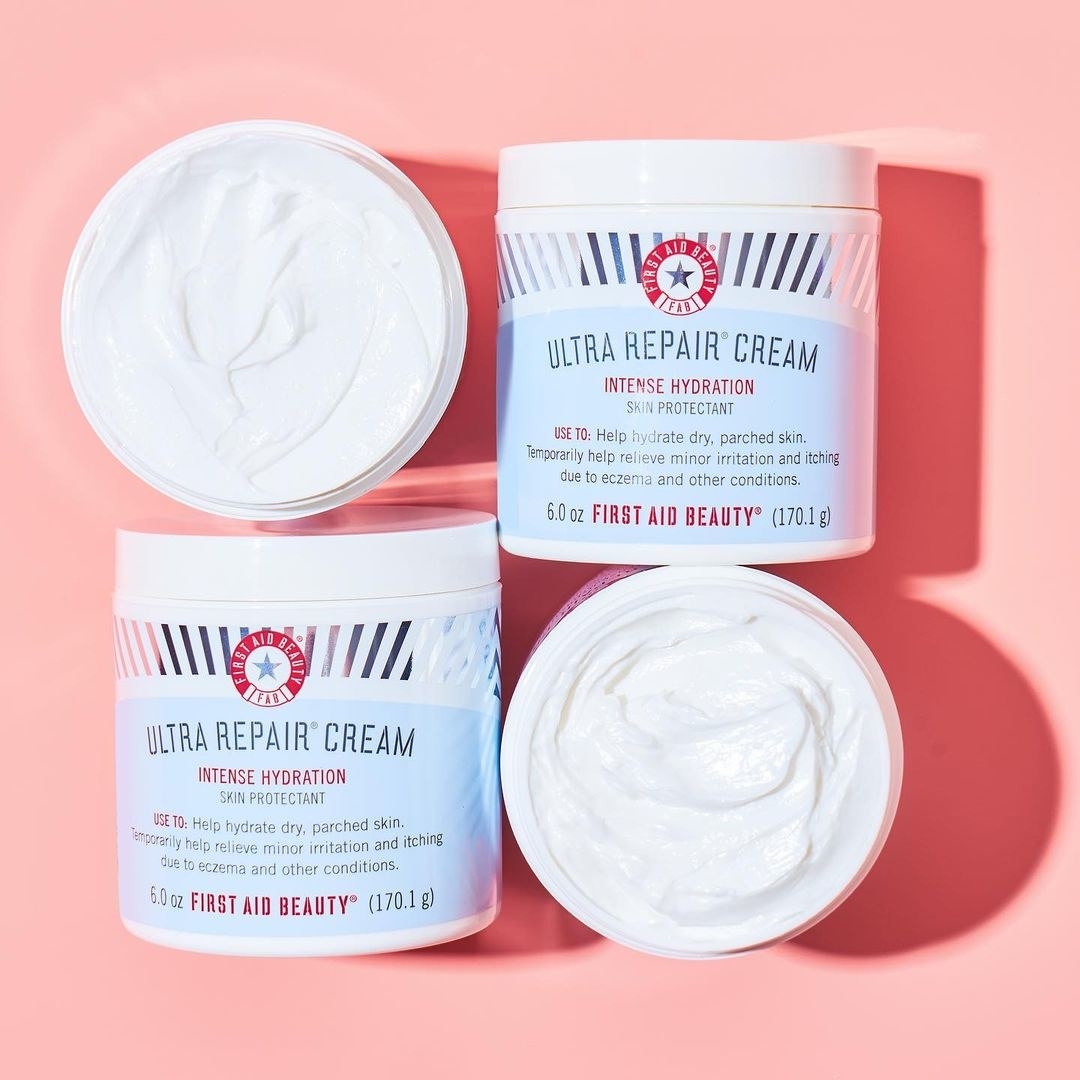 Four tubs of moisturizer on a plain background Two are open and filled to the top and two are closed and lying on their backs