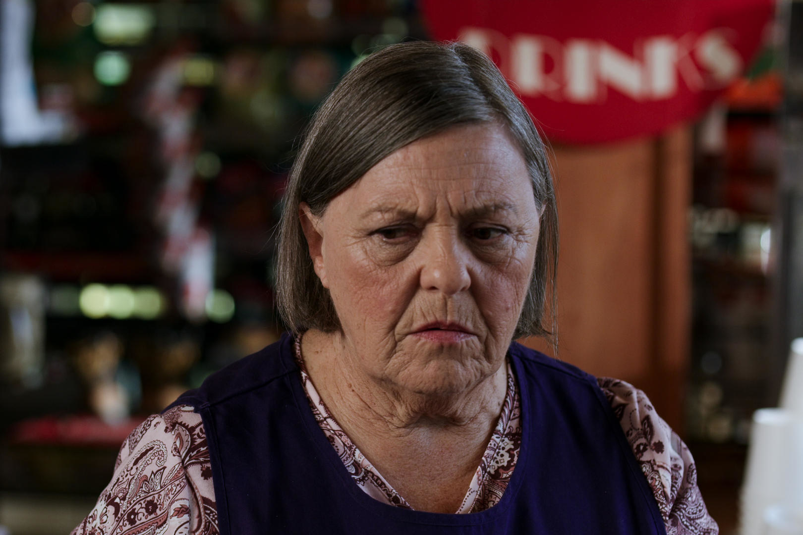 Connie in her shop with a serious look on her face