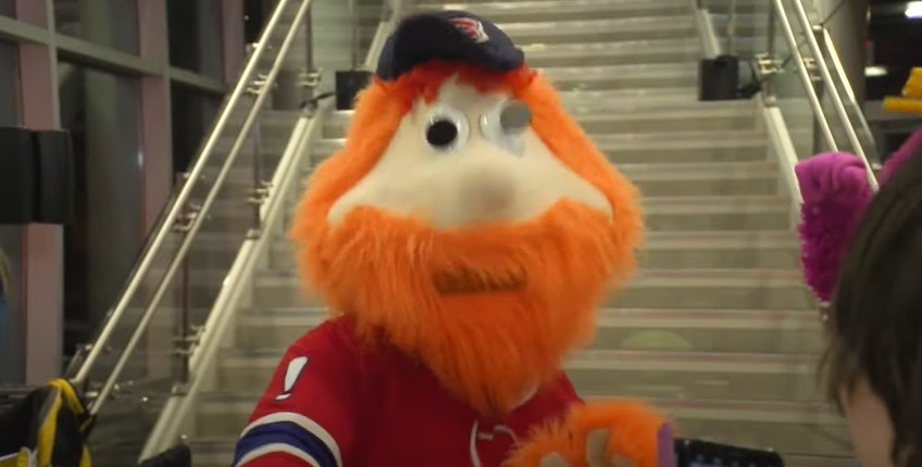 Youppi by a staircase.