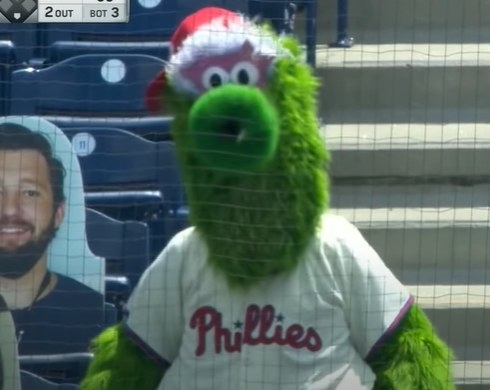 Phillie Phanatic behind a baseball net.