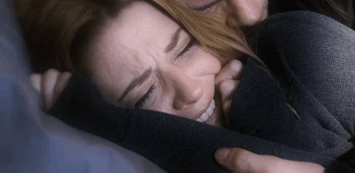 Mel's husband holding her in a flashback image