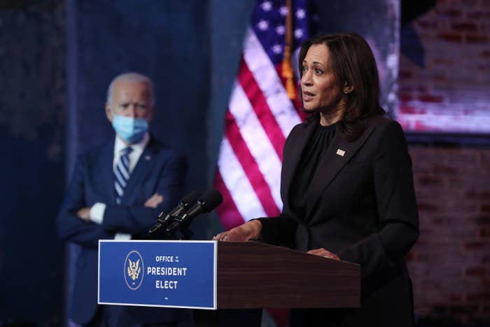 U.S. President-elect Joe Biden listens as Vice President-elect Kamala Harris addresses the media about the Trump Administration’s lawsuit to overturn the Affordable Care Act on November 10, 2020 at the Queen Theater in Wilmington, Delaware