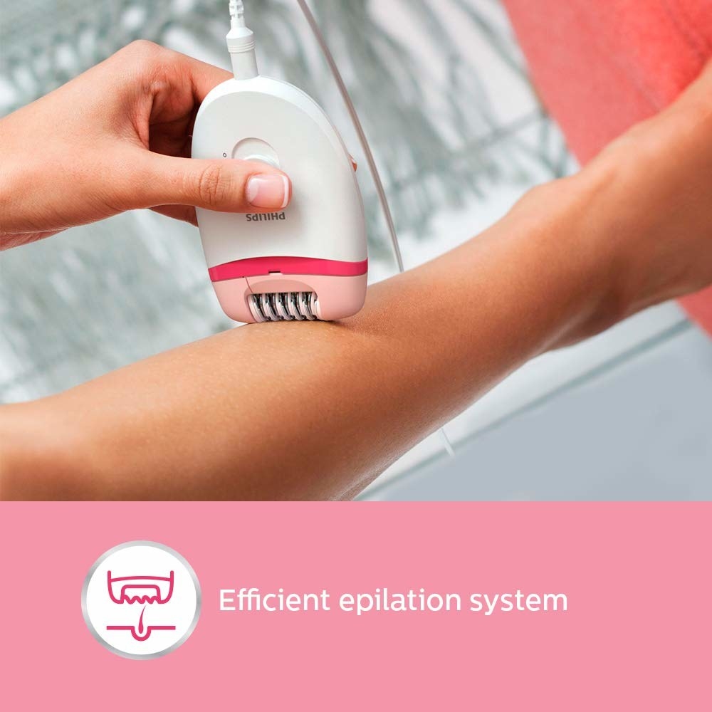 A pink and white epilator on skin