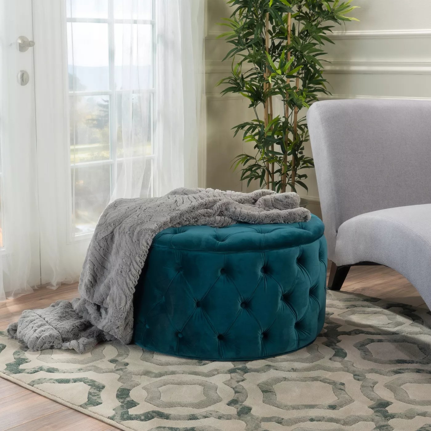 The tufted ottoman in teal