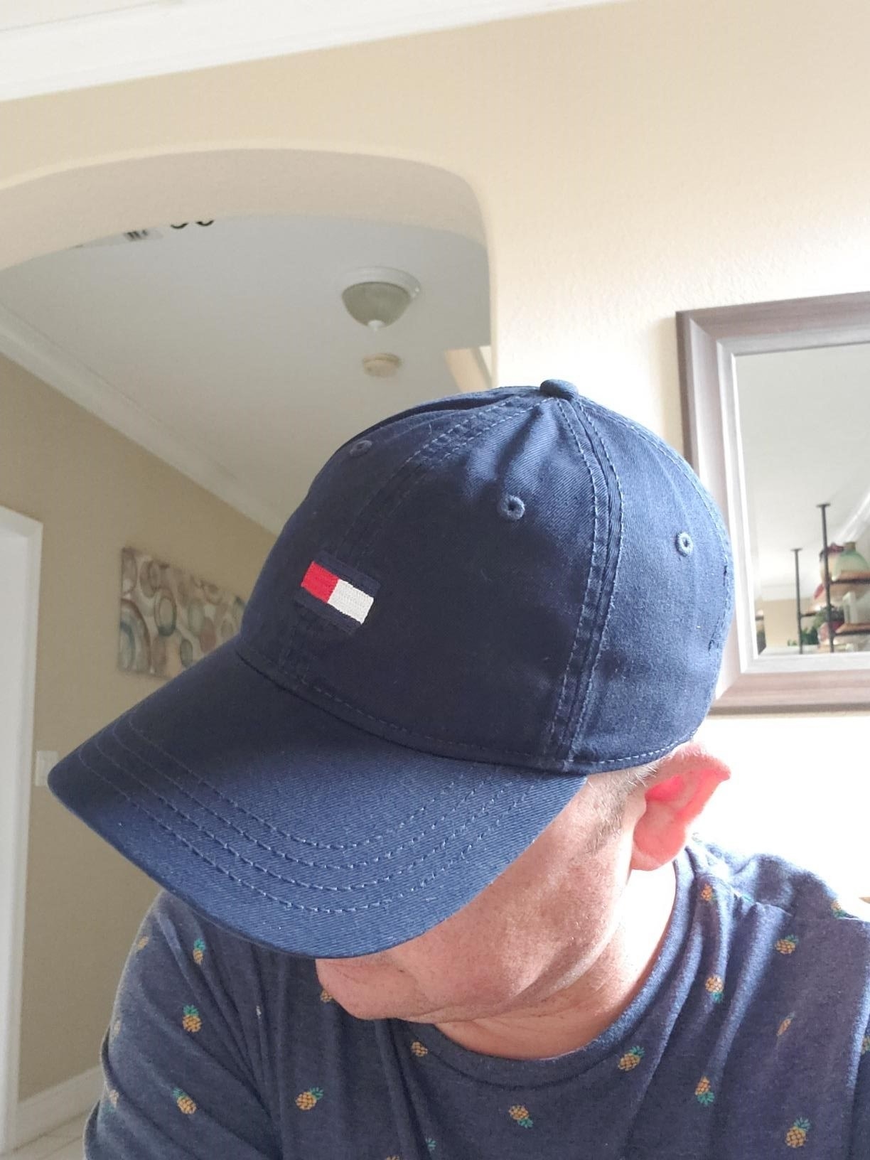 Amazon reviewer&#x27;s photo of wearing their navy blue cap