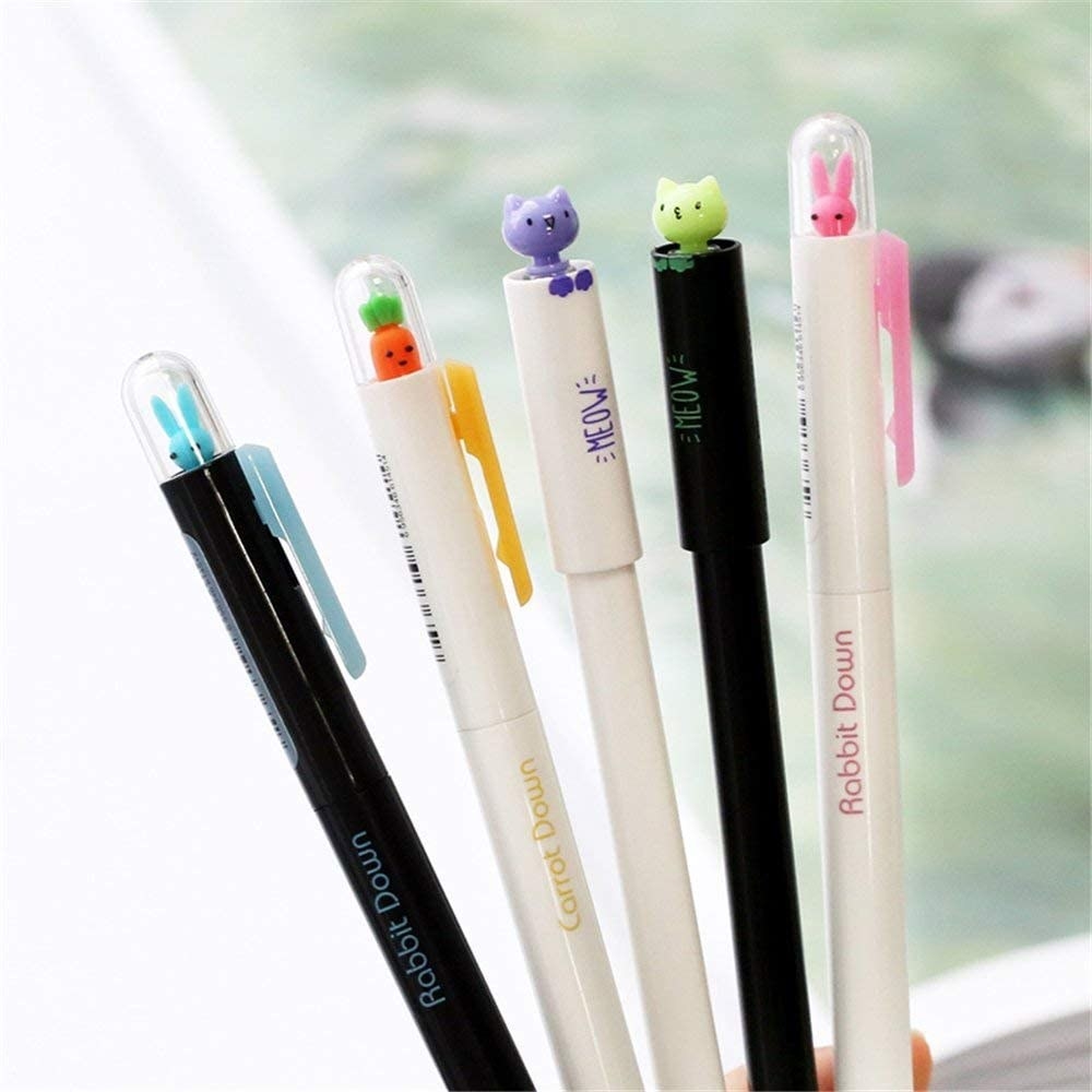 five pens with little figures inside plastic removable  domes
