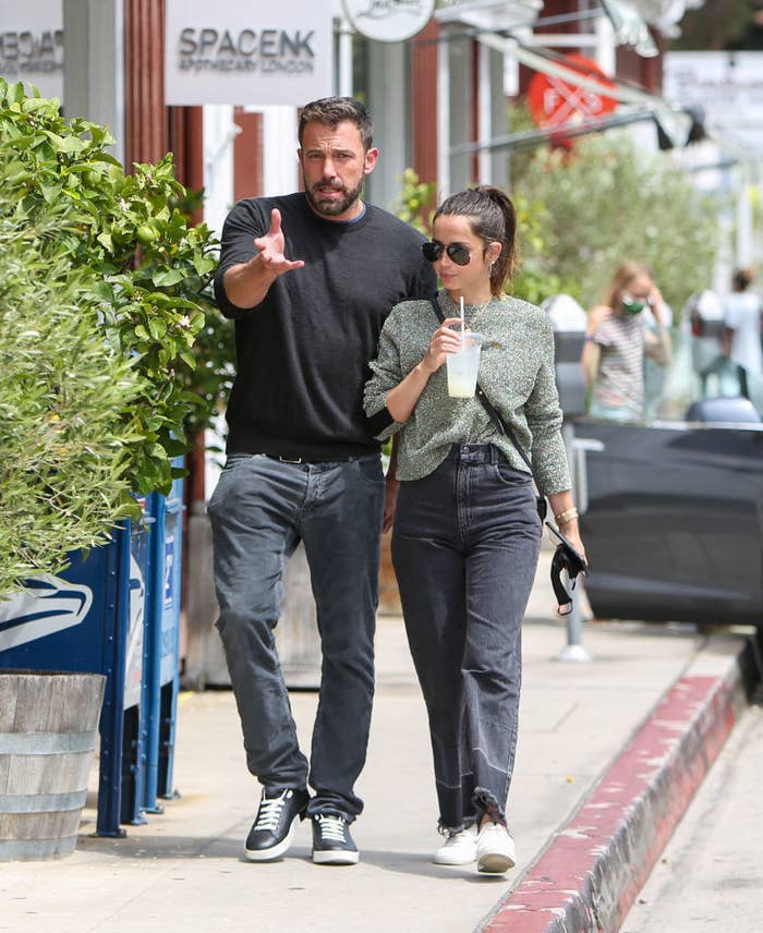 Ben Affleck and Ana de Armas walking down a sidewalk