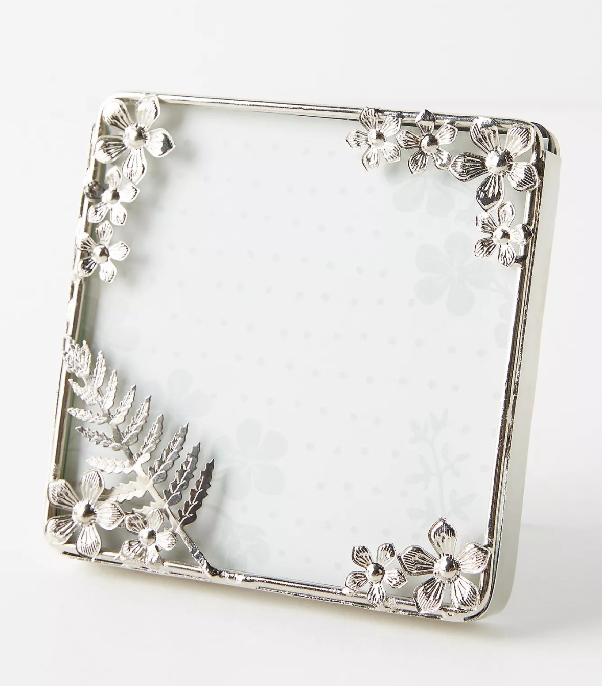 A silver frame with floral decorations