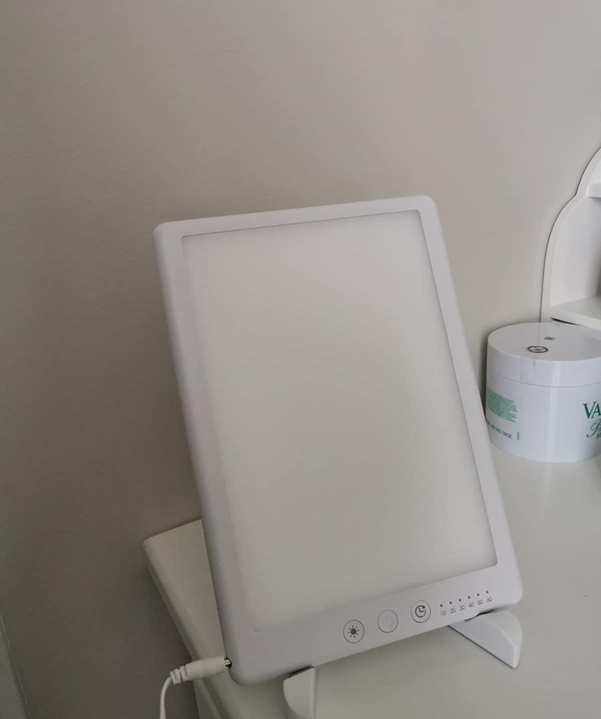 reviewer image of the ambother light therapy lamp on a counter
