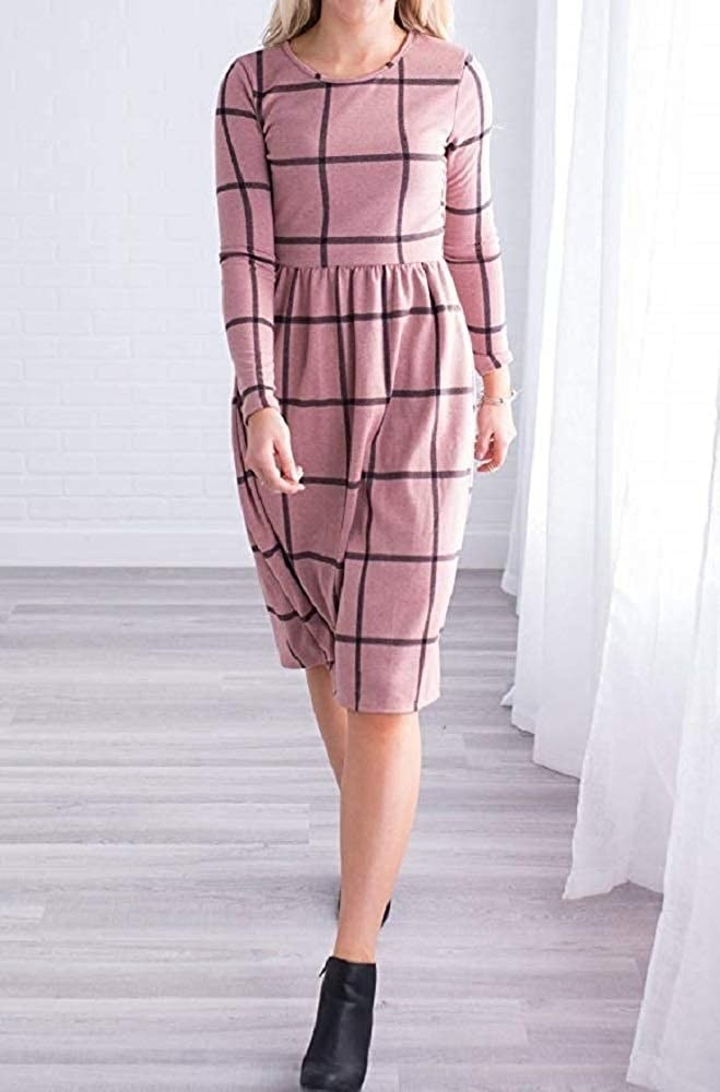 A model wearing the pink and black long sleeve dress