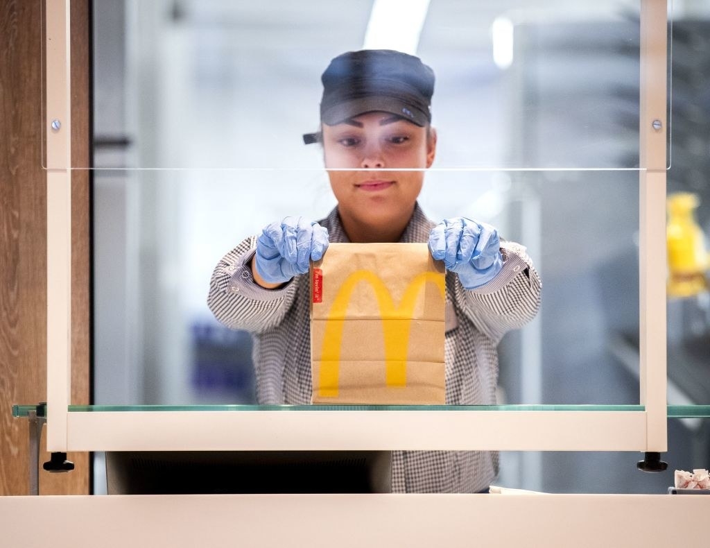 A McDonalds&#x27; employee holds up a food package at a test location in a restaurant in the Netherlands 